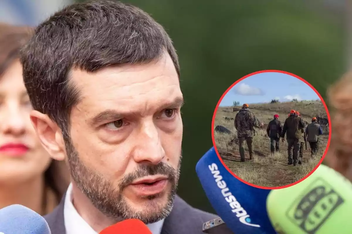 Un hombre de cabello corto y barba responde preguntas frente a varios micrófonos de colores, mientras en un círculo sobrepuesto se muestra a un grupo de personas caminando por el campo con ropa de caza.