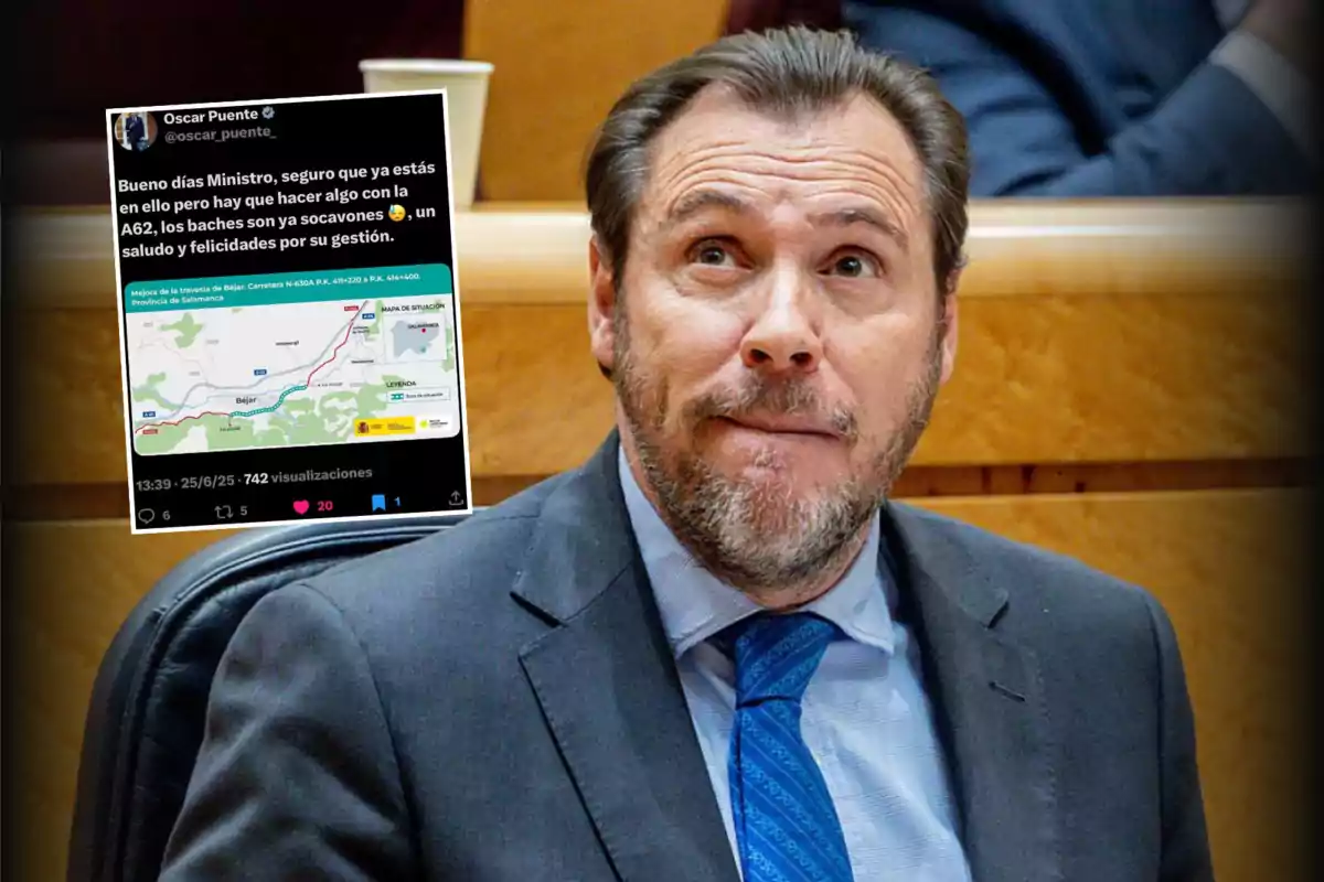 Hombre con barba y traje sentado en lo que parece ser un recinto oficial, con una imagen superpuesta de un tuit que muestra un mensaje dirigido a un ministro sobre el mal estado de la carretera A62 y un mapa de la zona afectada.