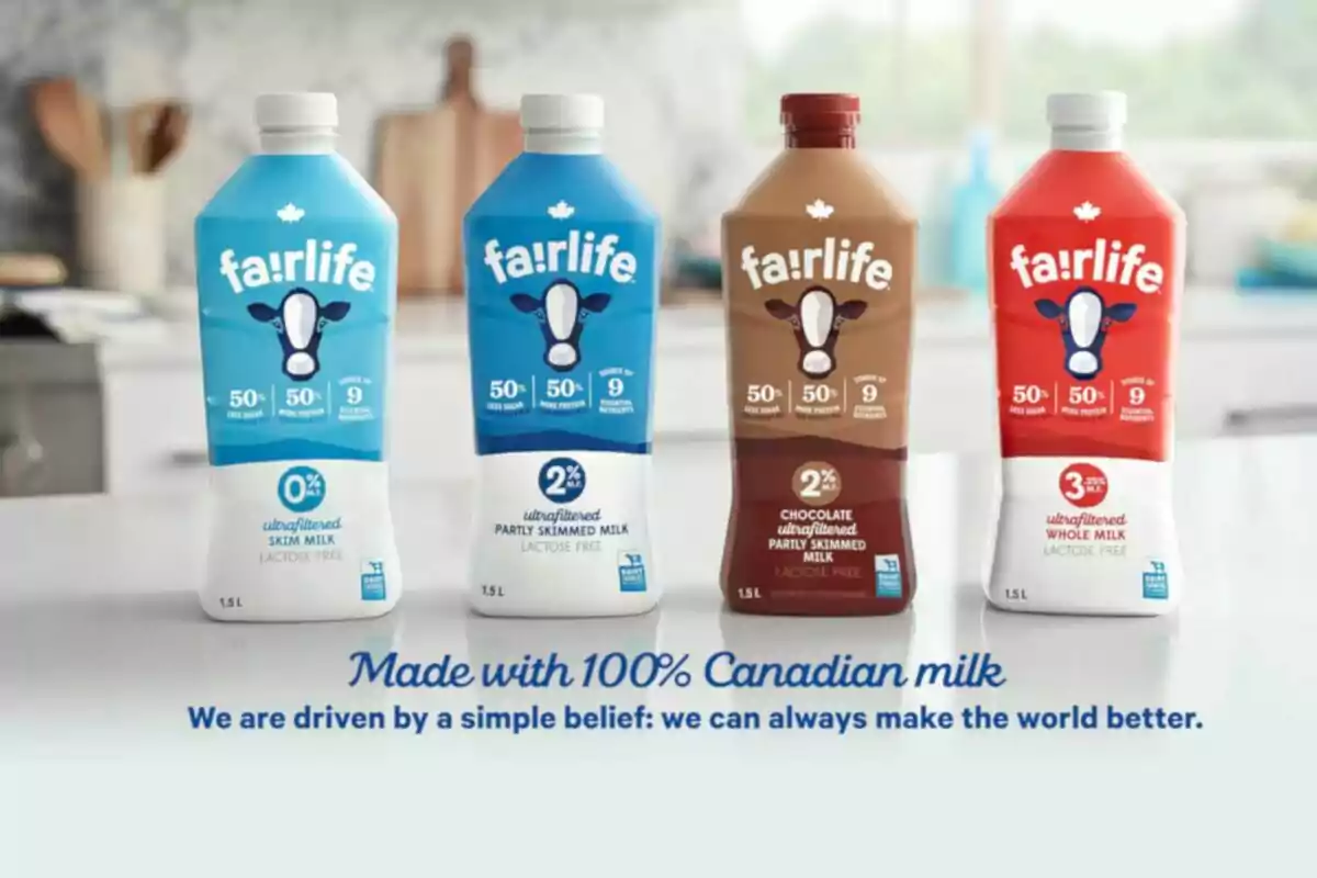Four Fairlife milk containers of different varieties and colors are lined up on a table in a modern kitchen, with the message Four Fairlife milk containers of different varieties and colors are lined up on a table in a modern kitchen, with the message