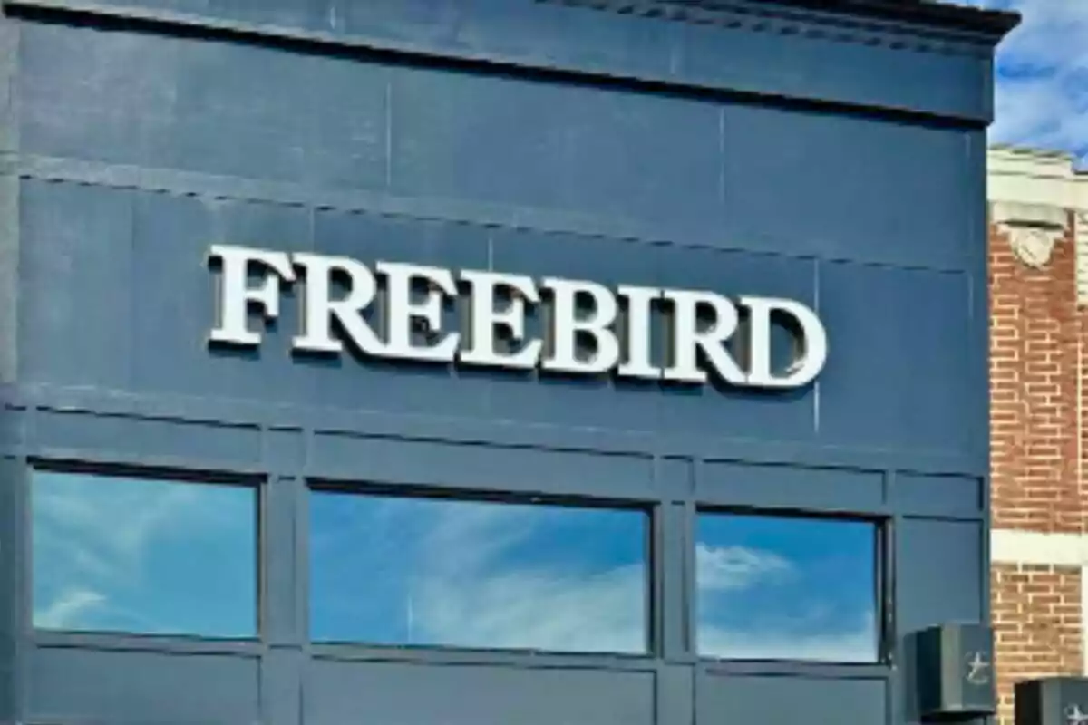 Facade of a dark blue building with the word FREEBIRD in large white letters