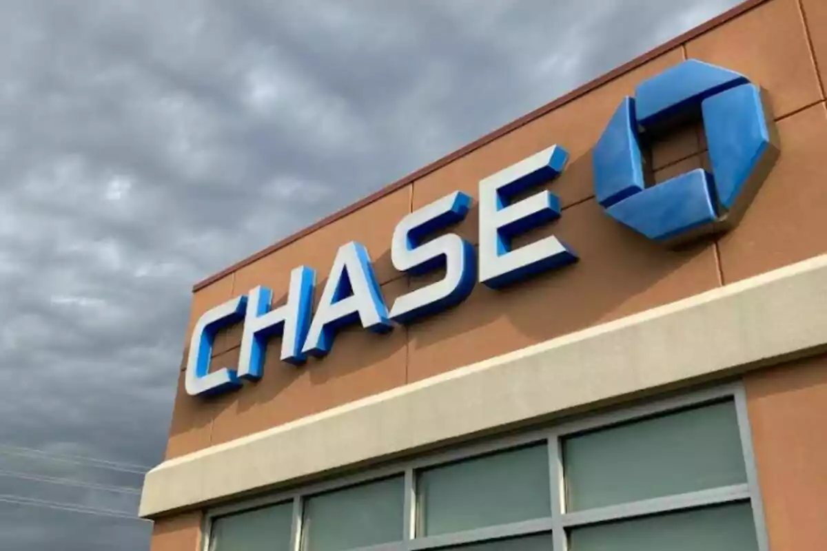 Facade of a Chase bank branch with the blue logo and large letters under a cloudy sky. Facade of a Chase bank branch with the blue logo and large letters under a cloudy sky.