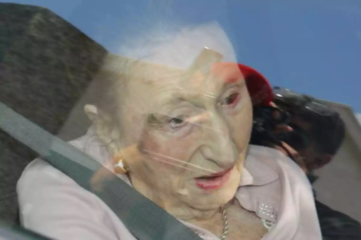 Infanta Margarita sitting in a car seat with her seatbelt on and the reflection of a person taking a photo in the window Infanta Margarita sitting in a car seat with her seatbelt on and the reflection of a person taking a photo in the window