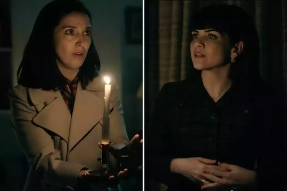 Luz y Gema en una habitación oscura, una sostiene una vela encendida y parece sorprendida, la otra la observa con expresión seria. Luz y Gema en una habitación oscura, una sostiene una vela encendida y parece sorprendida, la otra la observa con expresión seria.