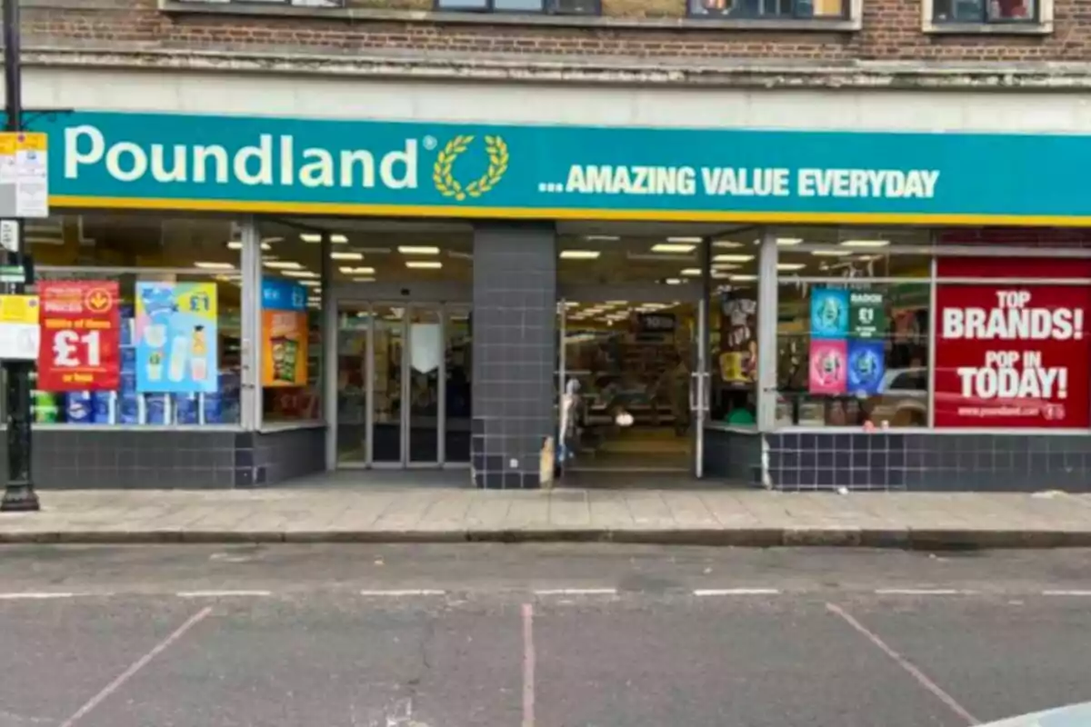 Facade of a Poundland store with a green and yellow sign and promotional posters in the windows Facade of a Poundland store with a green and yellow sign and promotional posters in the windows