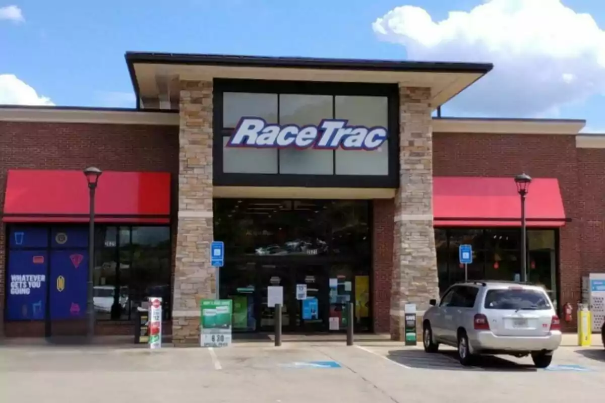 Storefront of a RaceTrac with a car parked in front and a blue sky with some clouds in the background Storefront of a RaceTrac with a car parked in front and a blue sky with some clouds in the background