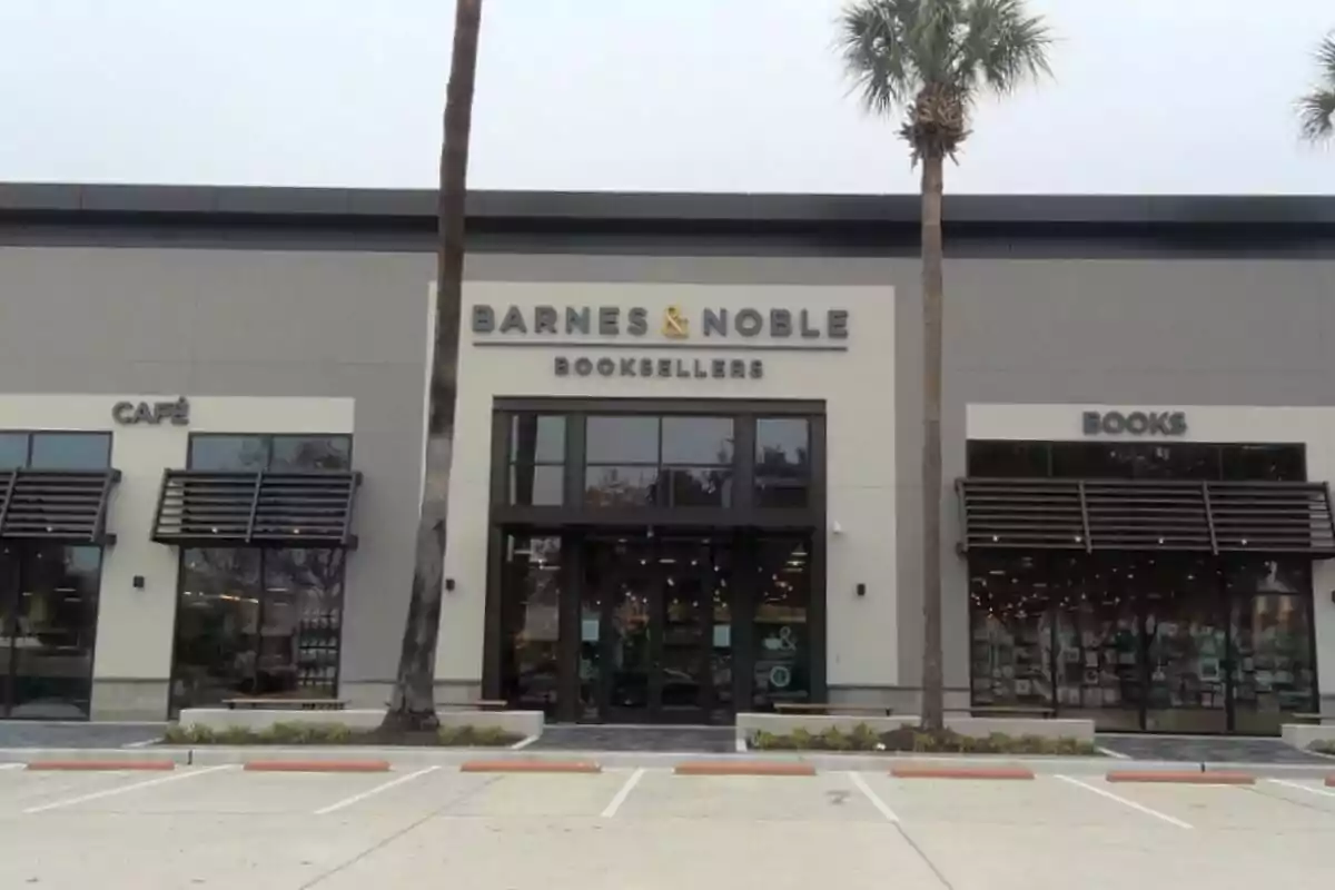 Facade of a Barnes and Noble store with palm trees and an empty parking lot in front Facade of a Barnes and Noble store with palm trees and an empty parking lot in front