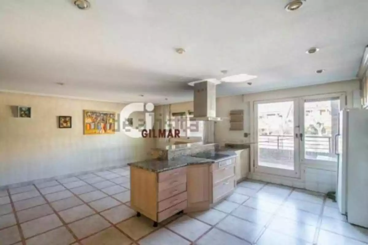 Spacious and bright kitchen with a central granite island, light wood cabinets, large windows, and access to an outdoor terrace. Spacious and bright kitchen with a central granite island, light wood cabinets, large windows, and access to an outdoor terrace.