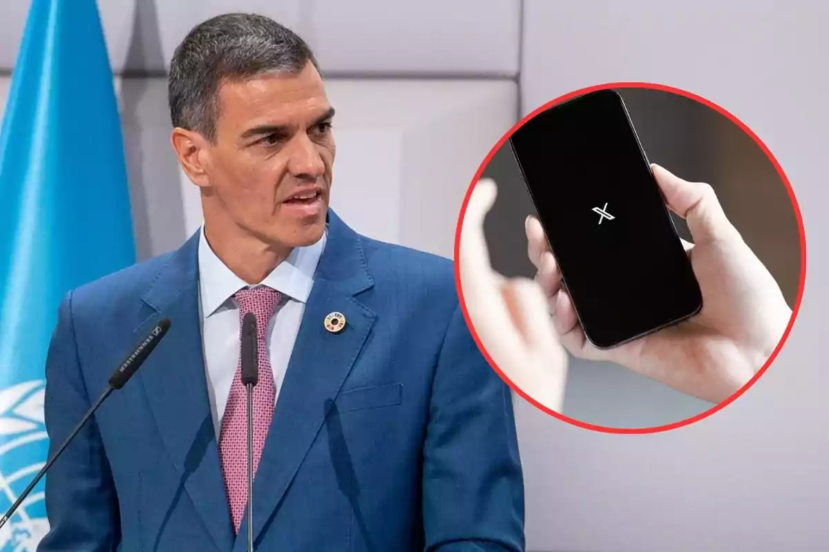 Un hombre con traje azul y corbata rosa habla frente a un micrófono mientras al fondo aparece una bandera azul y un círculo muestra una mano sosteniendo un teléfono móvil con el logo de X en la pantalla.