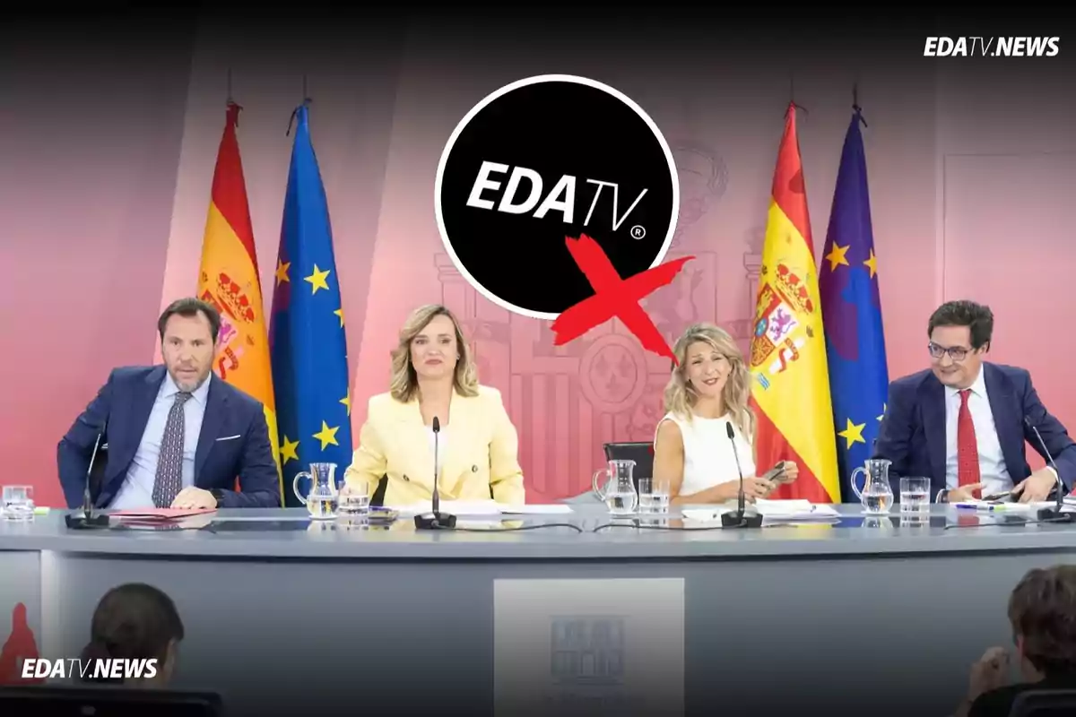 Cuatro personas sentadas en una mesa de conferencia con banderas de España y la Unión Europea al fondo y un logotipo de EDA TV tachado en la parte superior de la imagen