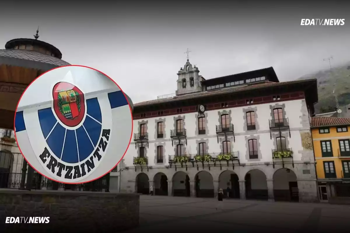 Edificio de un ayuntamiento en una plaza con un recuadro que muestra el escudo y el nombre de la Ertzaintza