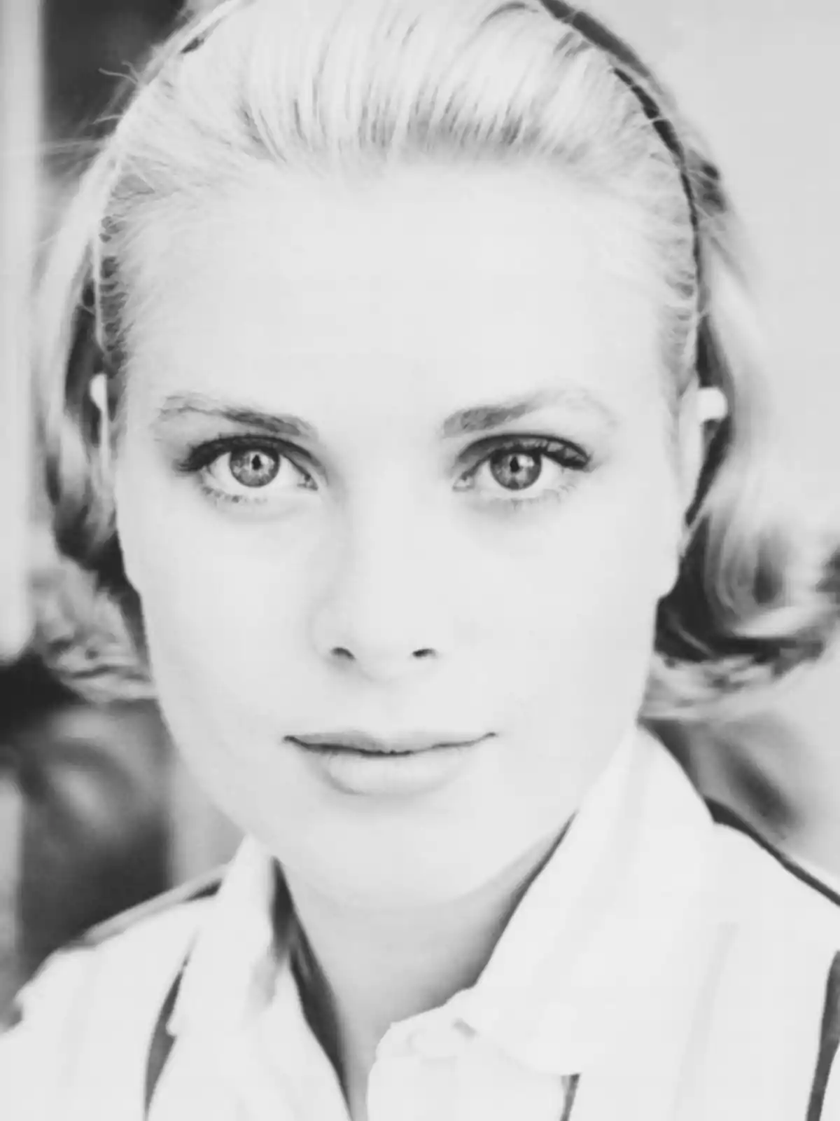 Black and white portrait of a young woman with light, short hair and a headband looking directly at the camera Black and white portrait of a young woman with light, short hair and a headband looking directly at the camera