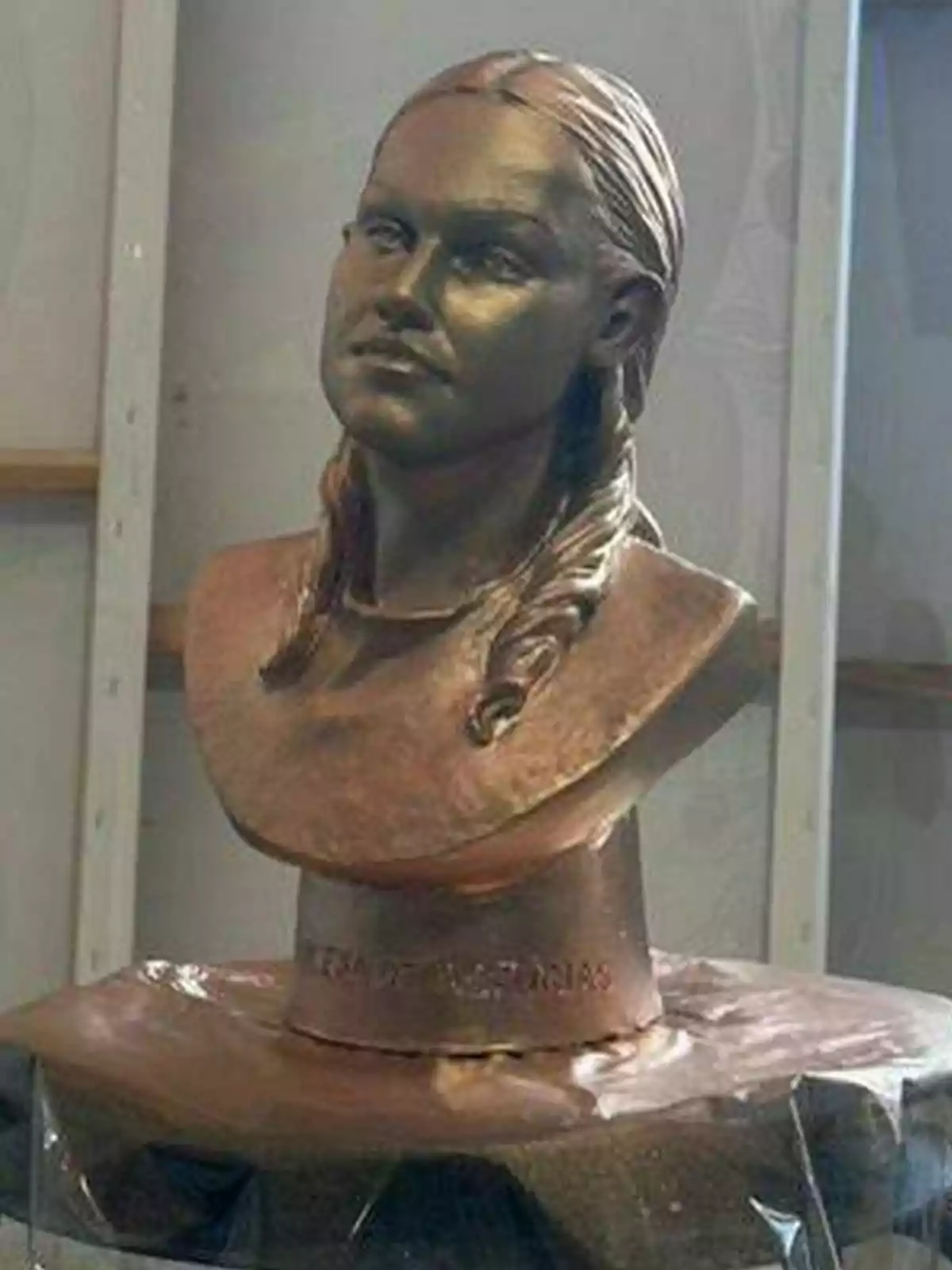 Bronze bust of Princess Leonor with her hair tied in two braids on a pedestal. Bronze bust of Princess Leonor with her hair tied in two braids on a pedestal.