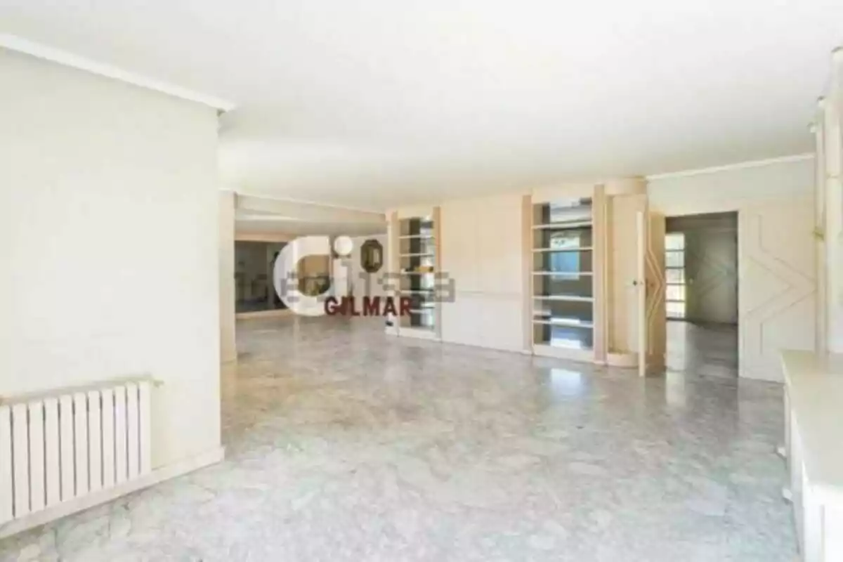Spacious and bright living room with marble flooring, built-in shelves, and light-colored walls. Spacious and bright living room with marble flooring, built-in shelves, and light-colored walls.