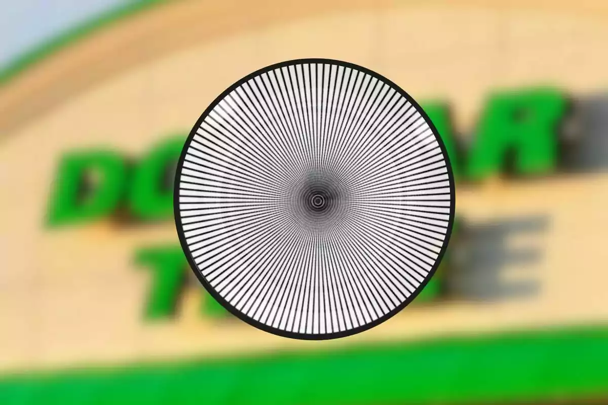 Circle with black and white radial lines in the center of a blurry image of a green and yellow sign. Circle with black and white radial lines in the center of a blurry image of a green and yellow sign.