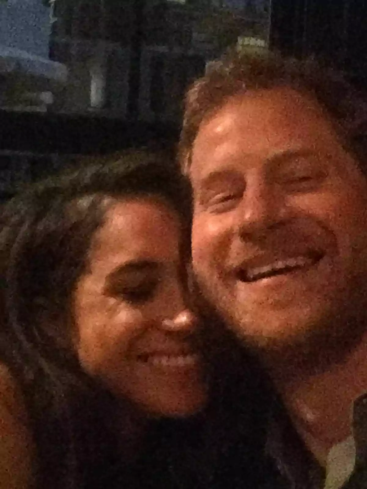 Meghan Markle and Prince Harry hugging, smiling, and enjoying a moment together. Meghan Markle and Prince Harry hugging, smiling, and enjoying a moment together.