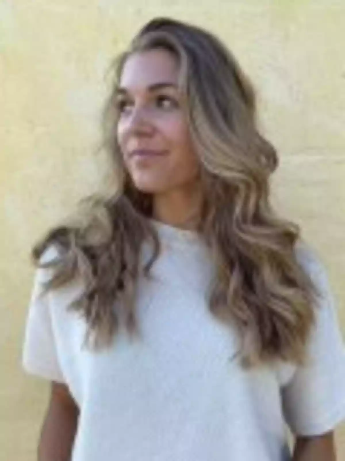 Emma Nygaard wearing a light-colored jersey posing in front of a blurred yellow wall Emma Nygaard wearing a light-colored jersey posing in front of a blurred yellow wall