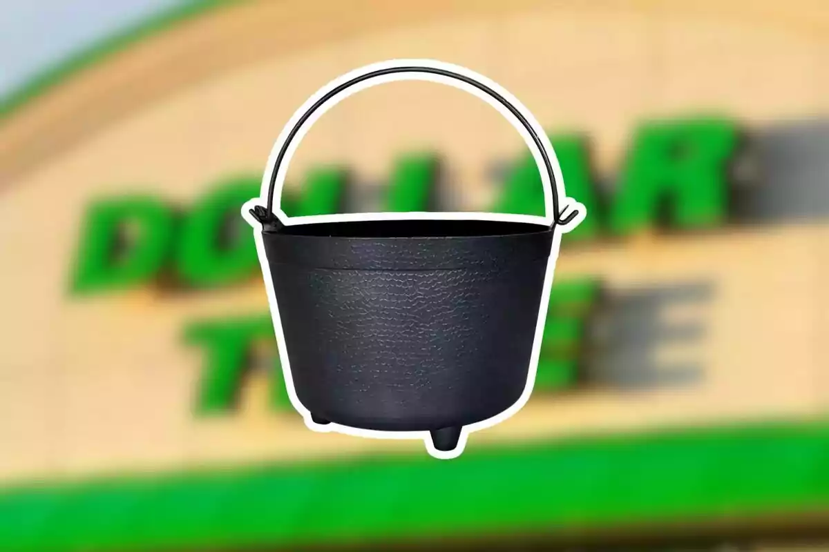 A black plastic cauldron with a handle in front of a blurry Dollar Tree sign A black plastic cauldron with a handle in front of a blurry Dollar Tree sign