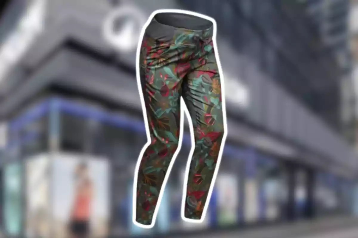 Pantalón deportivo con estampado de hojas en tonos verdes y rojos sobre un fondo urbano desenfocado Pantalón deportivo con estampado de hojas en tonos verdes y rojos sobre un fondo urbano desenfocado