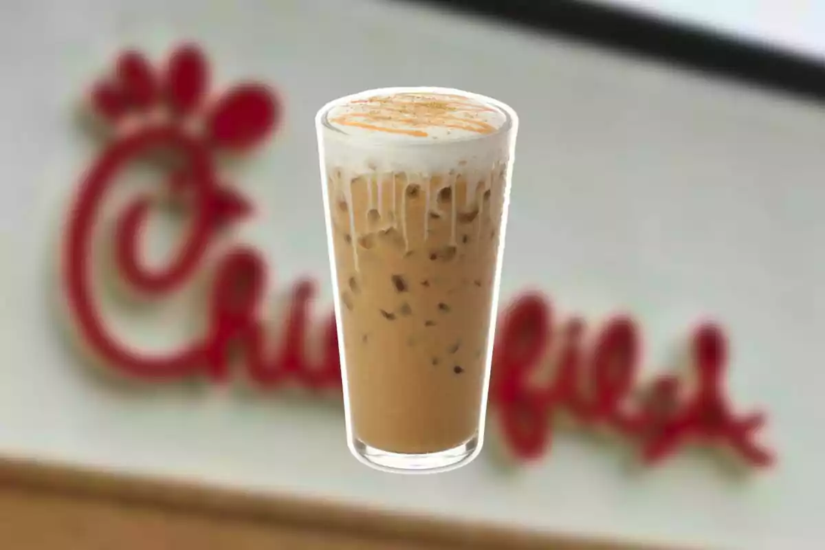 Iced coffee cup with cream and cinnamon in front of a blurry Chick-fil-A sign Iced coffee cup with cream and cinnamon in front of a blurry Chick-fil-A sign