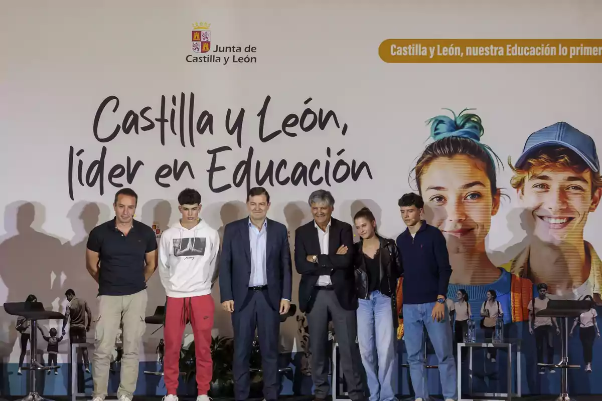 Un grupo de personas posando frente a un cartel que promociona la educación en Castilla y León Un grupo de personas posando frente a un cartel que promociona la educación en Castilla y León