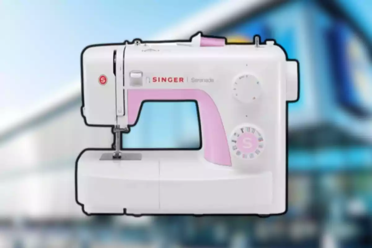 Máquina de coser blanca con detalles rosas sobre un fondo desenfocado Máquina de coser blanca con detalles rosas sobre un fondo desenfocado