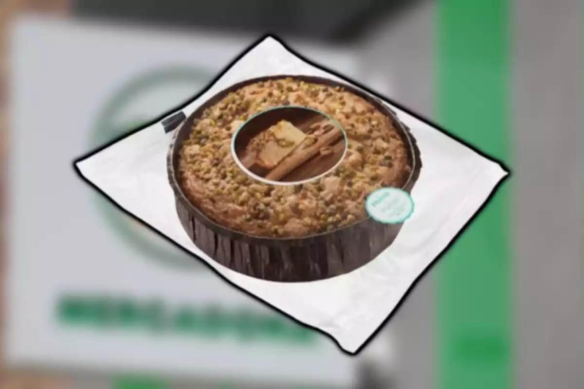 Pastel redondo cubierto con trozos de pistache sobre un fondo borroso