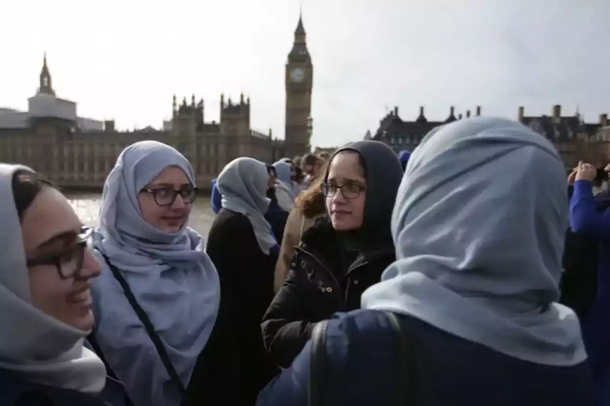 Grupo de mujeres con hiyab conversando al aire libre con el Big Ben y el Palacio de Westminster al fondo en Londres Grupo de mujeres con hiyab conversando al aire libre con el Big Ben y el Palacio de Westminster al fondo en Londres