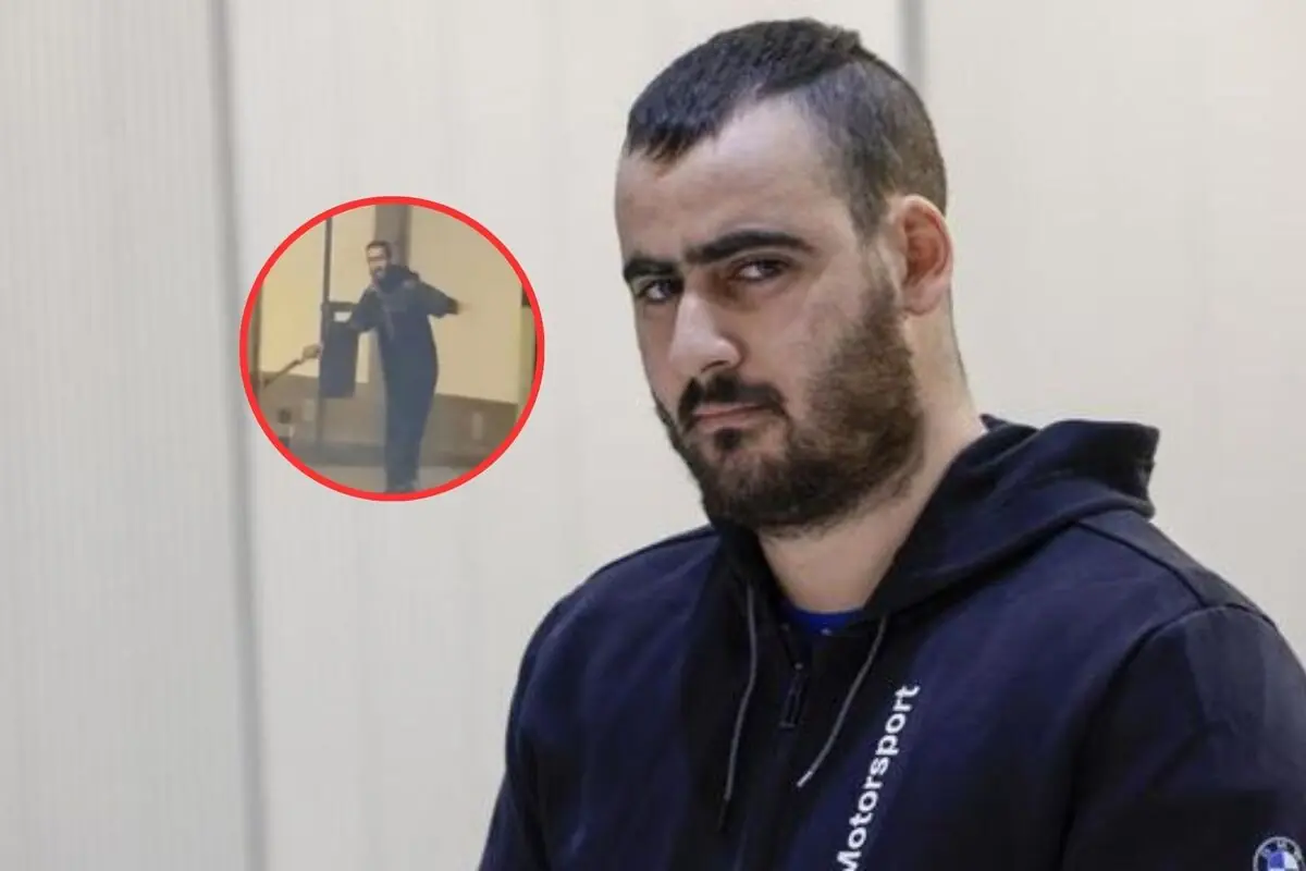 Hombre de barba y cabello corto con expresión seria, viste sudadera oscura y al fondo se muestra un recuadro con otra imagen de él en una postura diferente