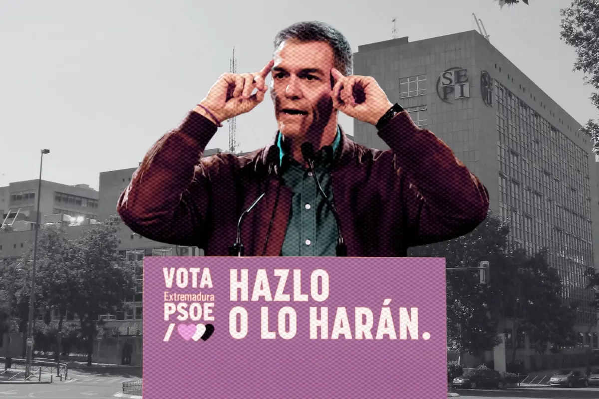 Un hombre hablando en un mitin político con un cartel que dice Vota Extremadura PSOE Hazlo o lo harán frente a un edificio de oficinas