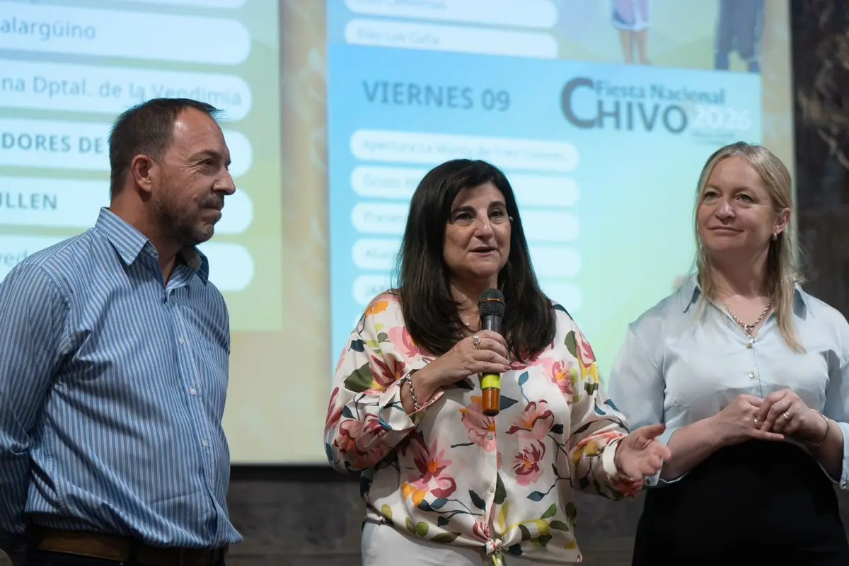 Tres personas de pie en un escenario durante una presentación pública la mujer del centro sostiene un micrófono mientras habla y a sus lados un hombre y otra mujer escuchan frente a una pantalla con información del evento Fiesta Nacional del Chivo 2026 Tres personas de pie en un escenario durante una presentación pública la mujer del centro sostiene un micrófono mientras habla y a sus lados un hombre y otra mujer escuchan frente a una pantalla con información del evento Fiesta Nacional del Chivo 2026