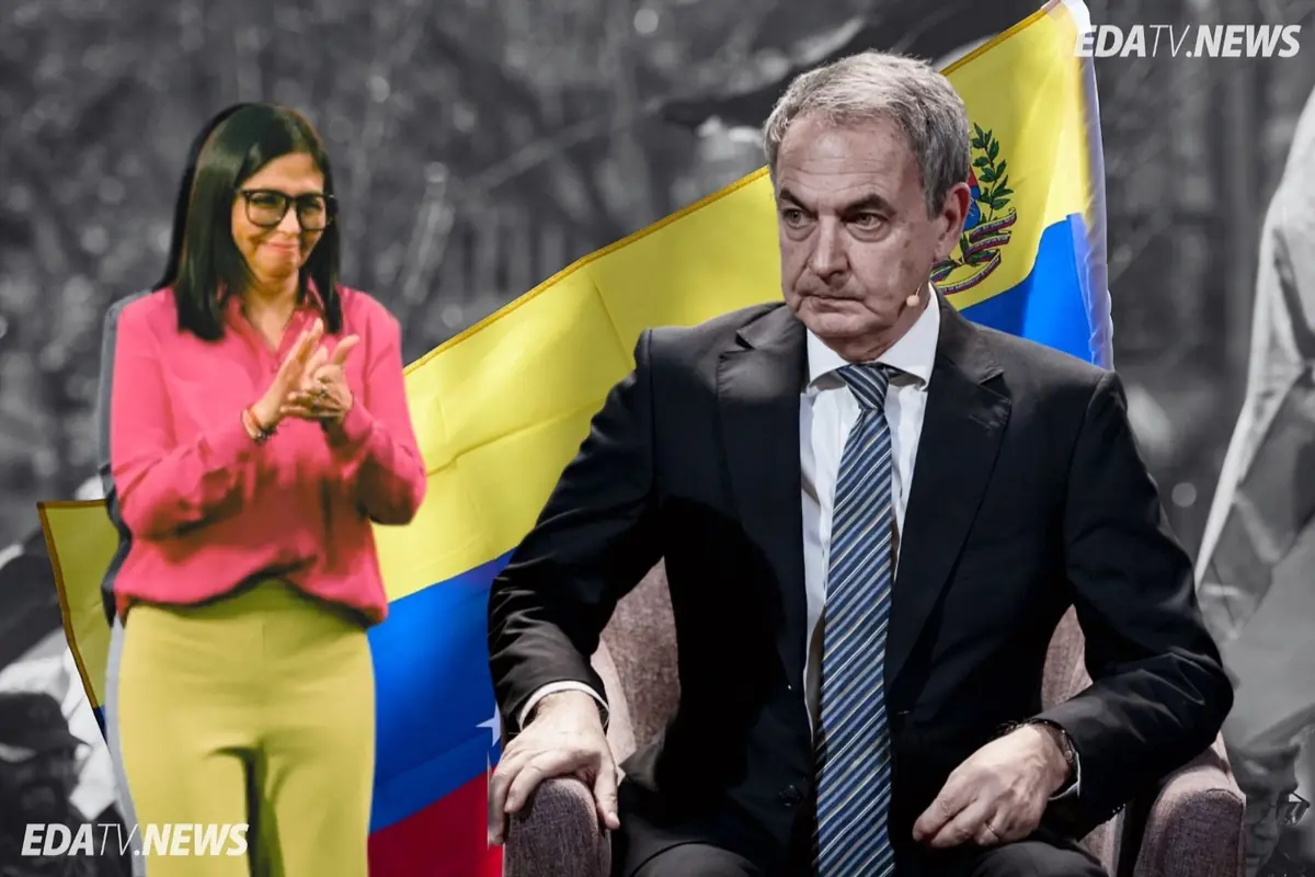 Hombre de traje sentado con gesto serio y mujer de camisa rosa aplaudiendo delante de una gran bandera de Venezuela con el logo de EDATV NEWS en la esquina