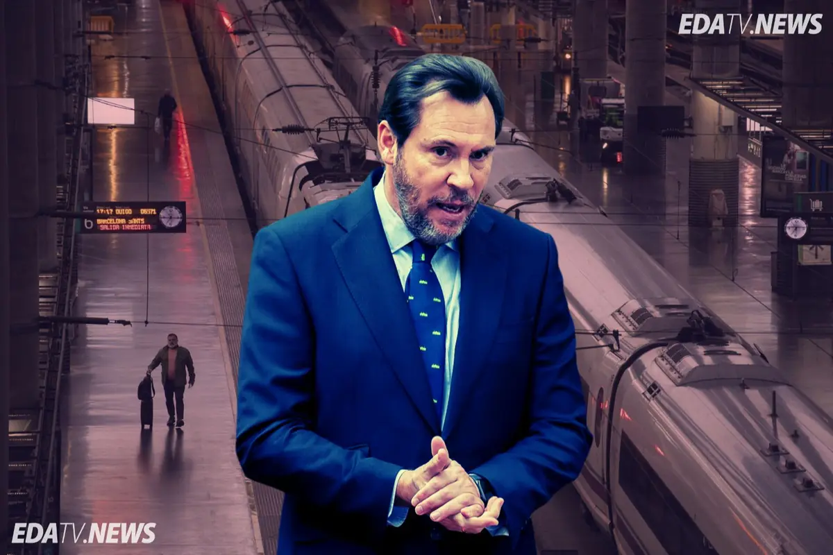 Hombre con traje azul hablando frente a andenes y trenes de alta velocidad en una estación ferroviaria con el logotipo EDATV NEWS en las esquinas