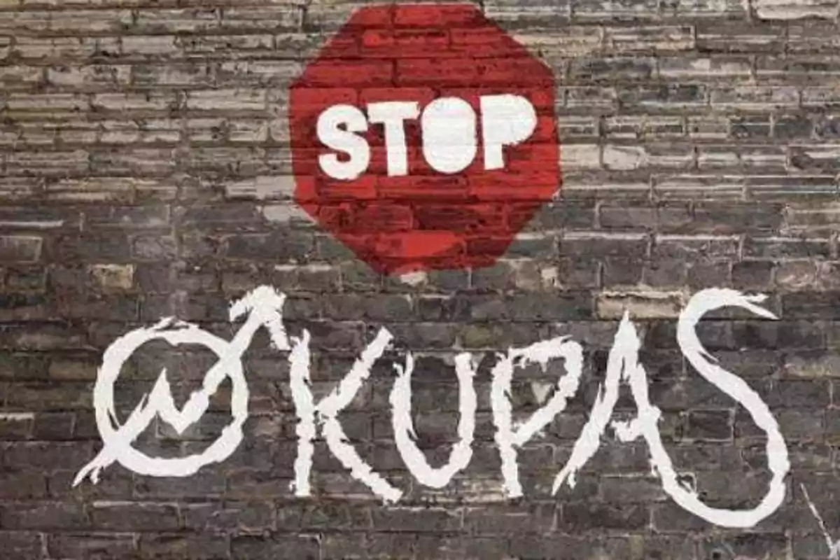 Se ve un muro de ladrillos con un símbolo de alto en rojo y la palabra Se ve un muro de ladrillos con un símbolo de alto en rojo y la palabra