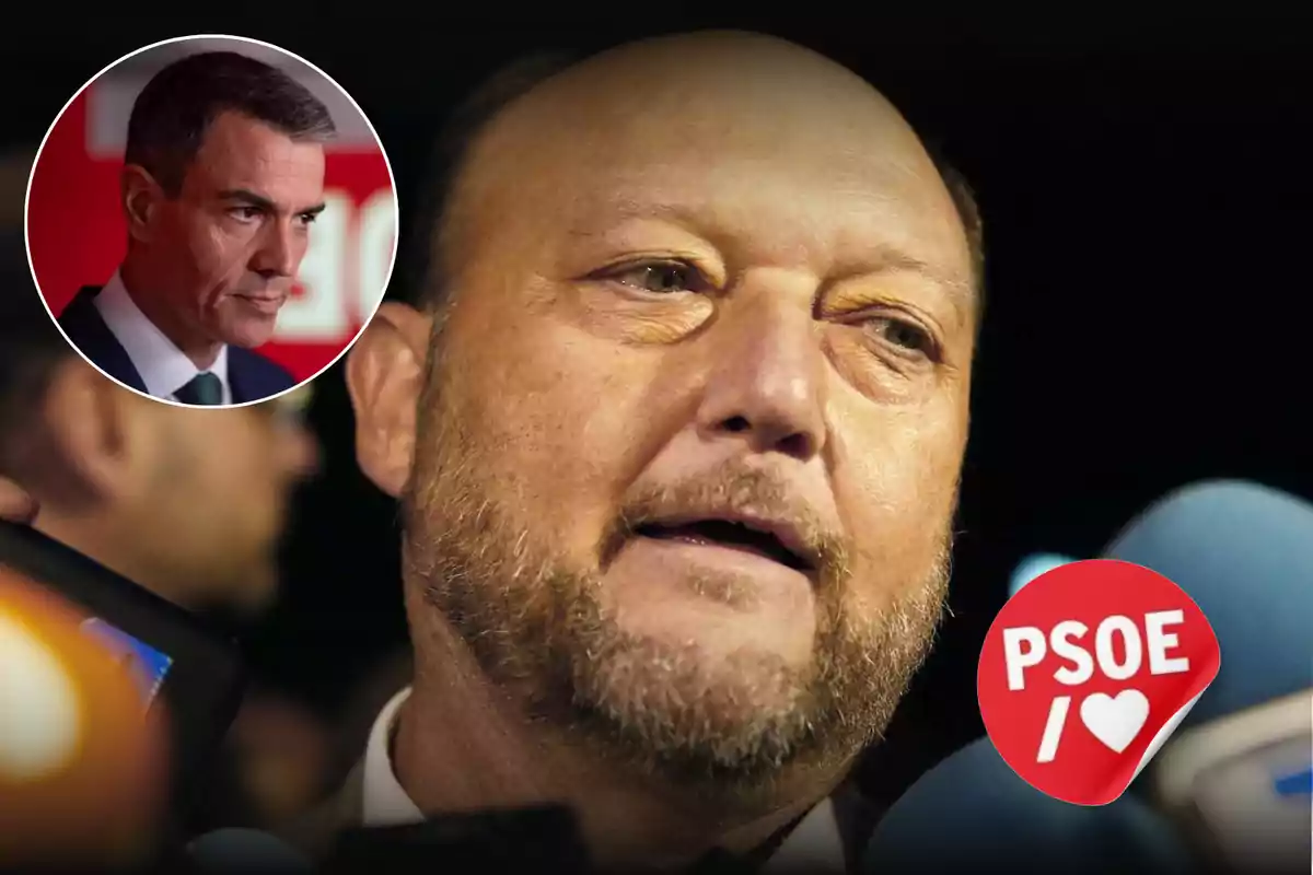 Primer plano de un hombre calvo y con barba hablando ante varios micrófonos con un círculo que muestra a otro hombre en el fondo y un logo rojo de PSOE con un corazón en la esquina inferior derecha