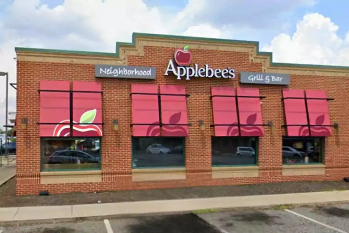 Facade of an Applebee's restaurant with red awnings and brick walls. Facade of an Applebee's restaurant with red awnings and brick walls.