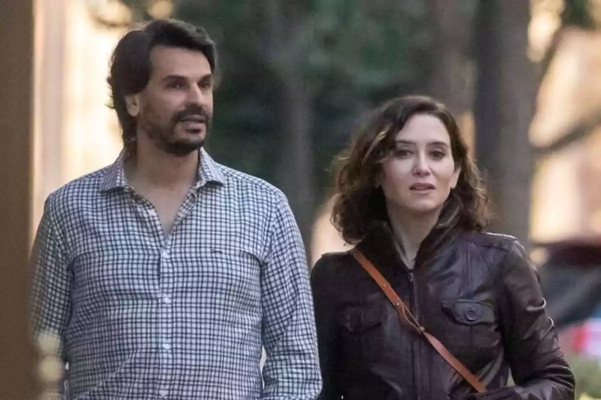 A couple walking down the street in an urban setting. A couple walking down the street in an urban setting.