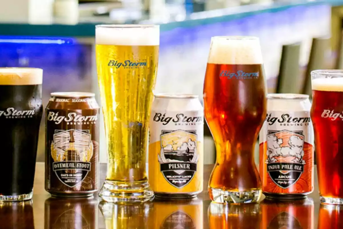 Variety of Big Storm beers in glasses and cans on a table Variety of Big Storm beers in glasses and cans on a table
