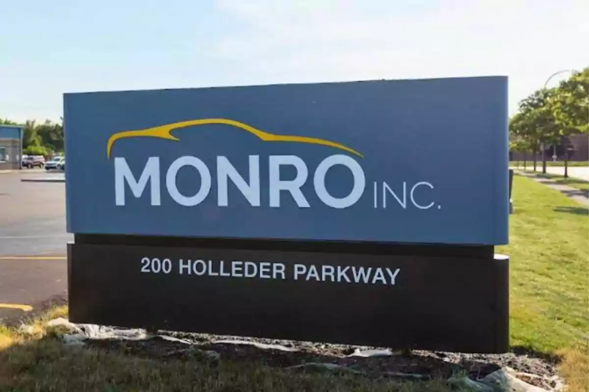 Monro Inc. sign with the address 200 Holleder Parkway in an outdoor area next to a street and grass. Monro Inc. sign with the address 200 Holleder Parkway in an outdoor area next to a street and grass.
