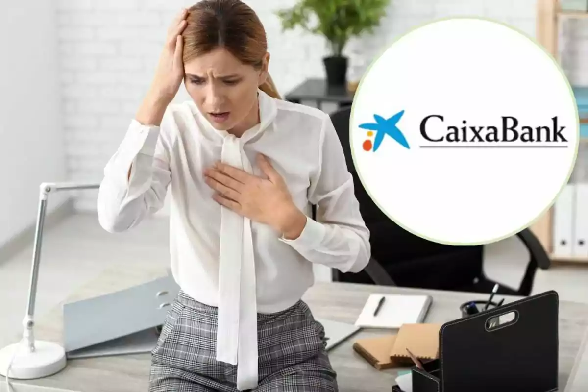 Una mujer en una oficina con expresión de preocupación, tocándose el pecho y la cabeza, con el logo de CaixaBank en la esquina superior derecha.