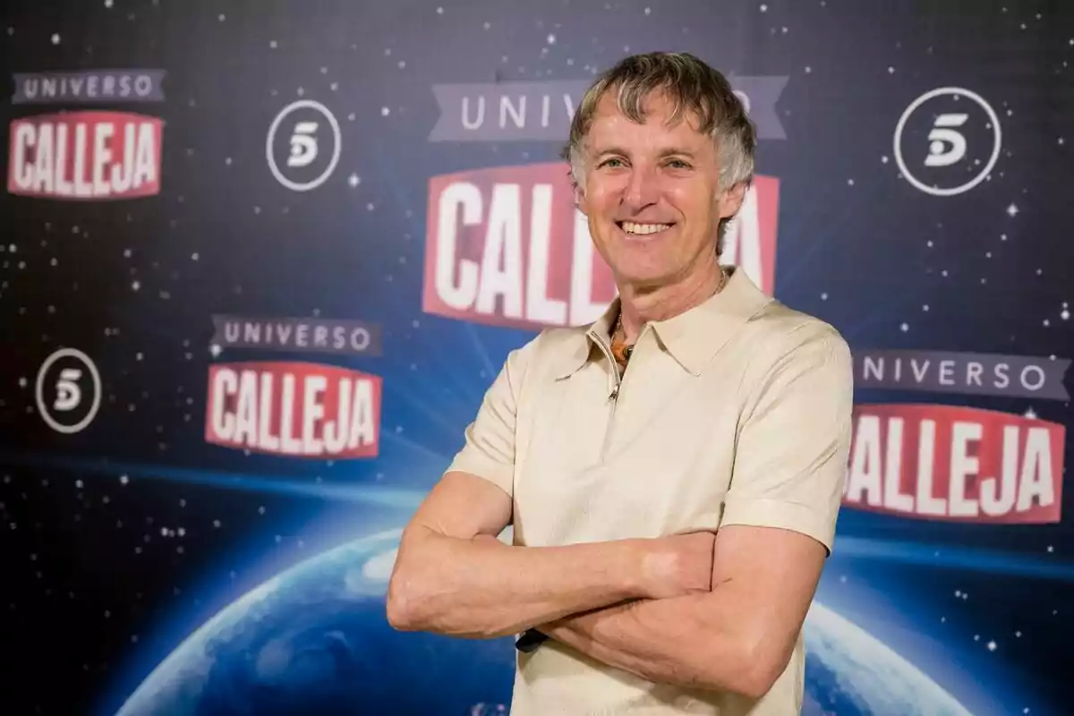 Jesús Calleja sonriente con los brazos cruzados frente a un fondo que dice Jesús Calleja sonriente con los brazos cruzados frente a un fondo que dice