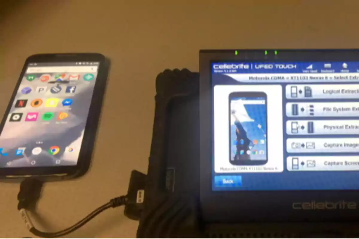 A smartphone connected to a digital data extraction device.