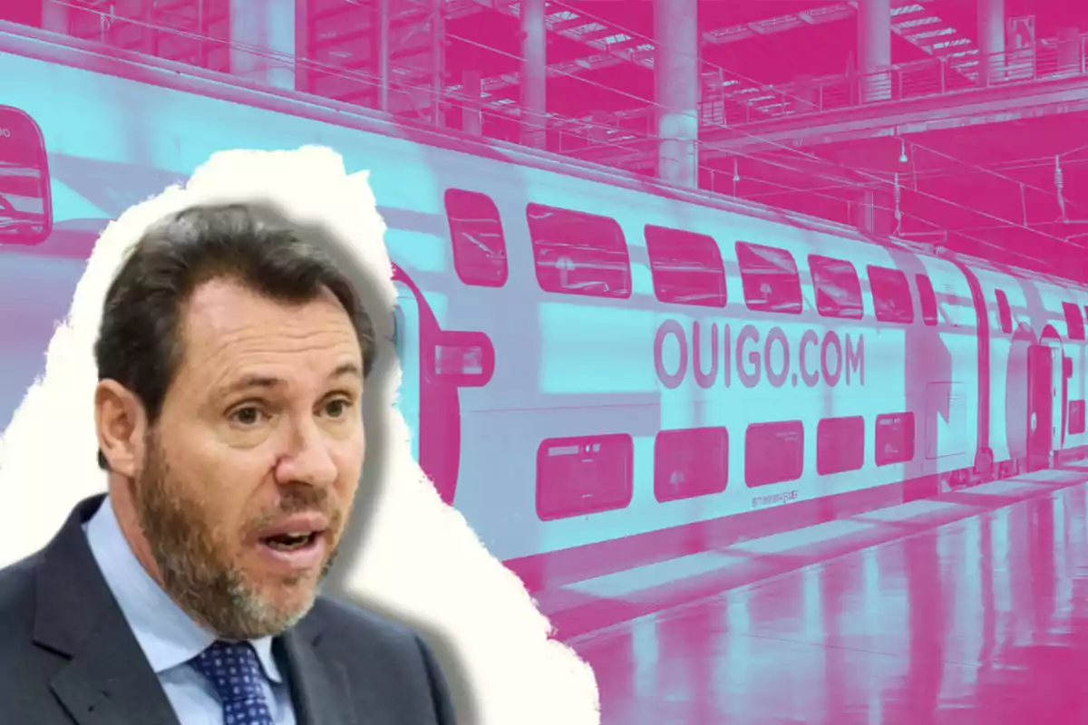 Un hombre con barba y traje aparece en primer plano con una expresión facial de sorpresa, mientras que en el fondo se ve un tren de dos pisos con el logo de OUIGO.COM en una estación con un filtro de color rosa y azul.