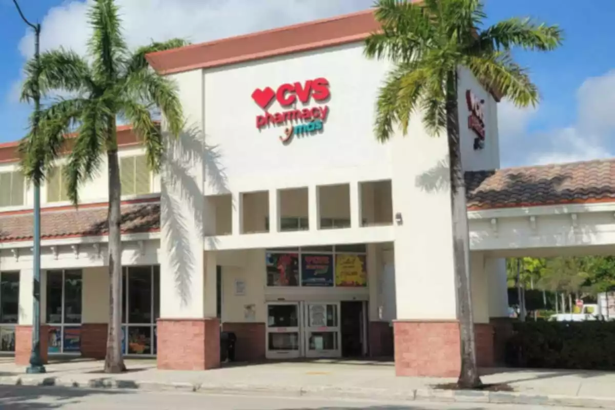 CVS Pharmacy storefront with palm trees in front and clear sky. CVS Pharmacy storefront with palm trees in front and clear sky.