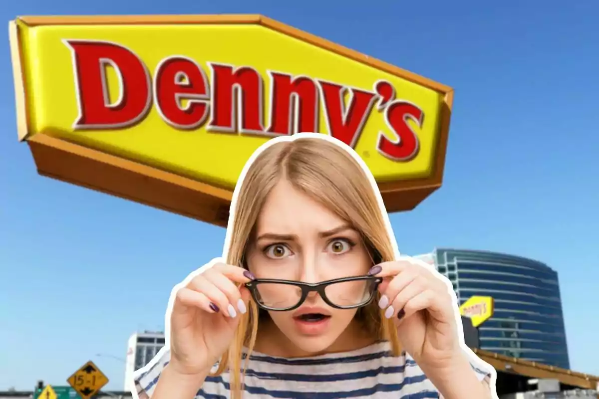 A woman with a surprised expression holds her glasses in front of a Denny's sign.