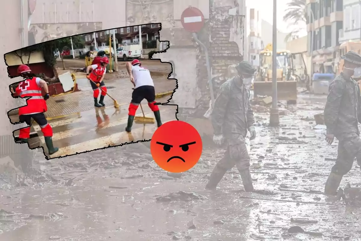 Personas con uniformes de la Cruz Roja limpiando una calle inundada mientras dos soldados caminan por una zona llena de escombros y barro. Un emoji de enojo está superpuesto en la imagen.