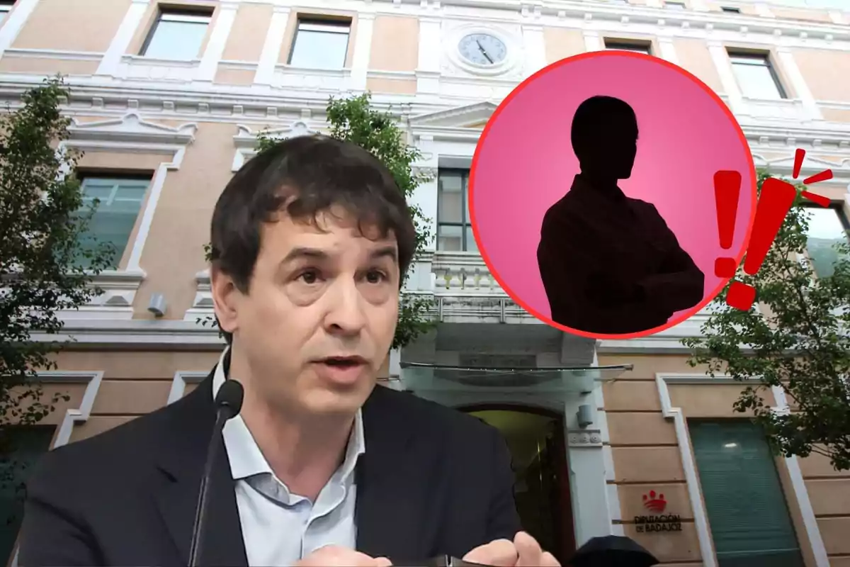 Un hombre hablando frente a un edificio con un círculo rojo que contiene la silueta de una persona y un signo de exclamación.