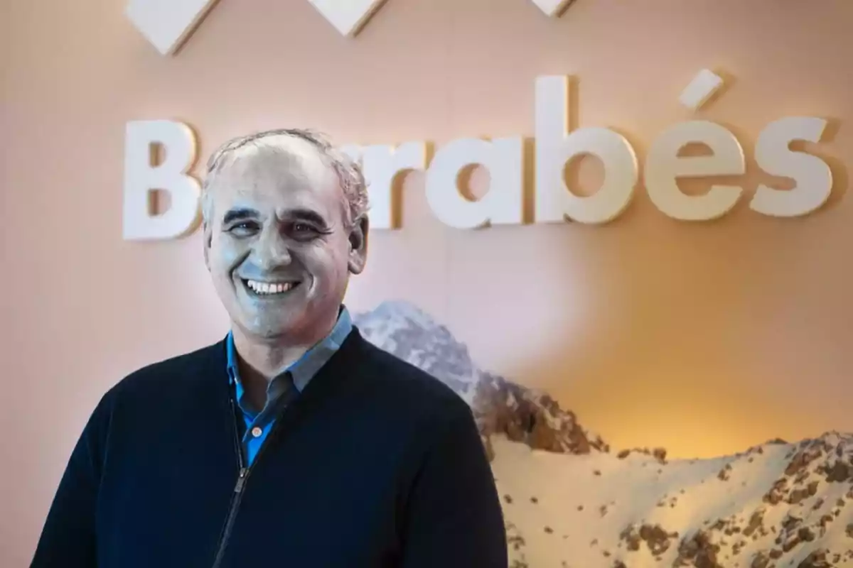 A smiling man with a background showing the name "Barrabés" and an image of mountains.