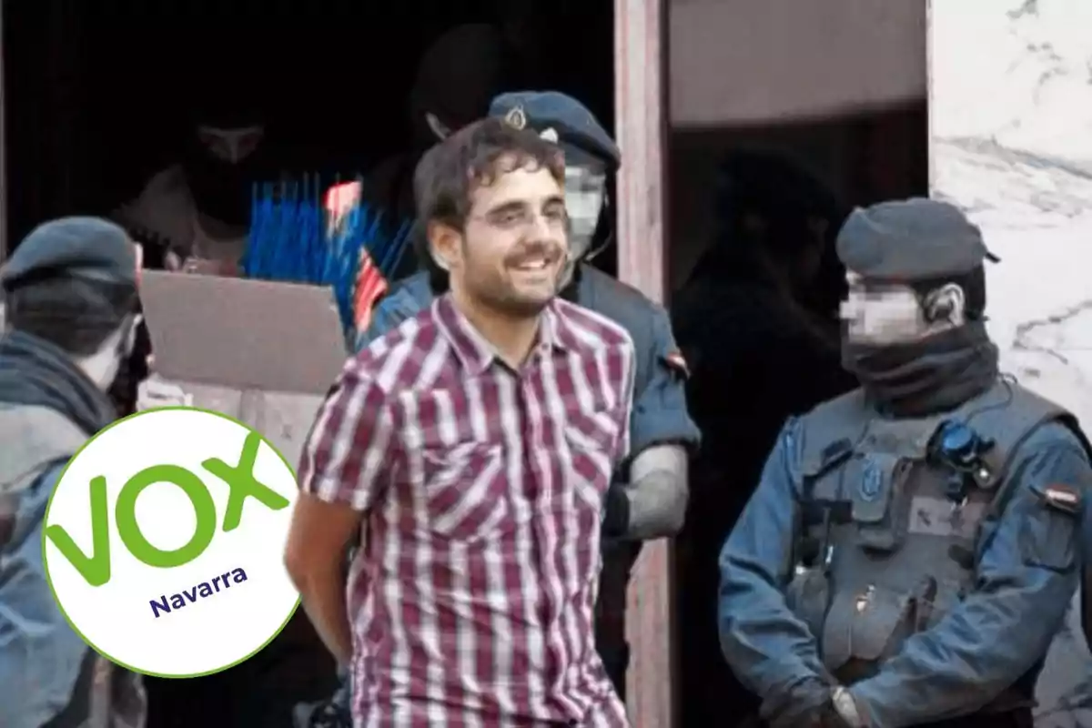 A man in a checkered jersey is escorted by masked security agents, while a Vox Navarra logo appears in the bottom left corner.