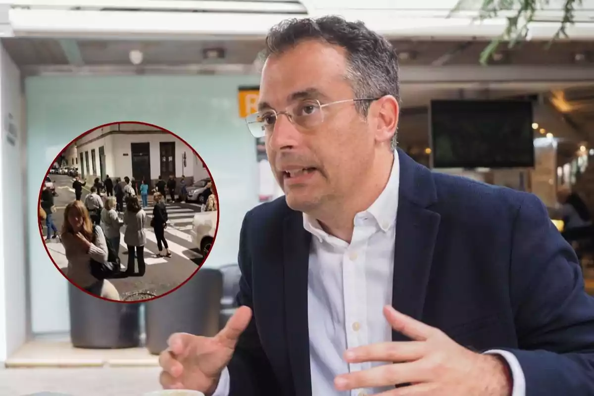 A man with glasses and a dark jacket gestures while speaking indoors, with an inset circular image showing a group of people on a street.