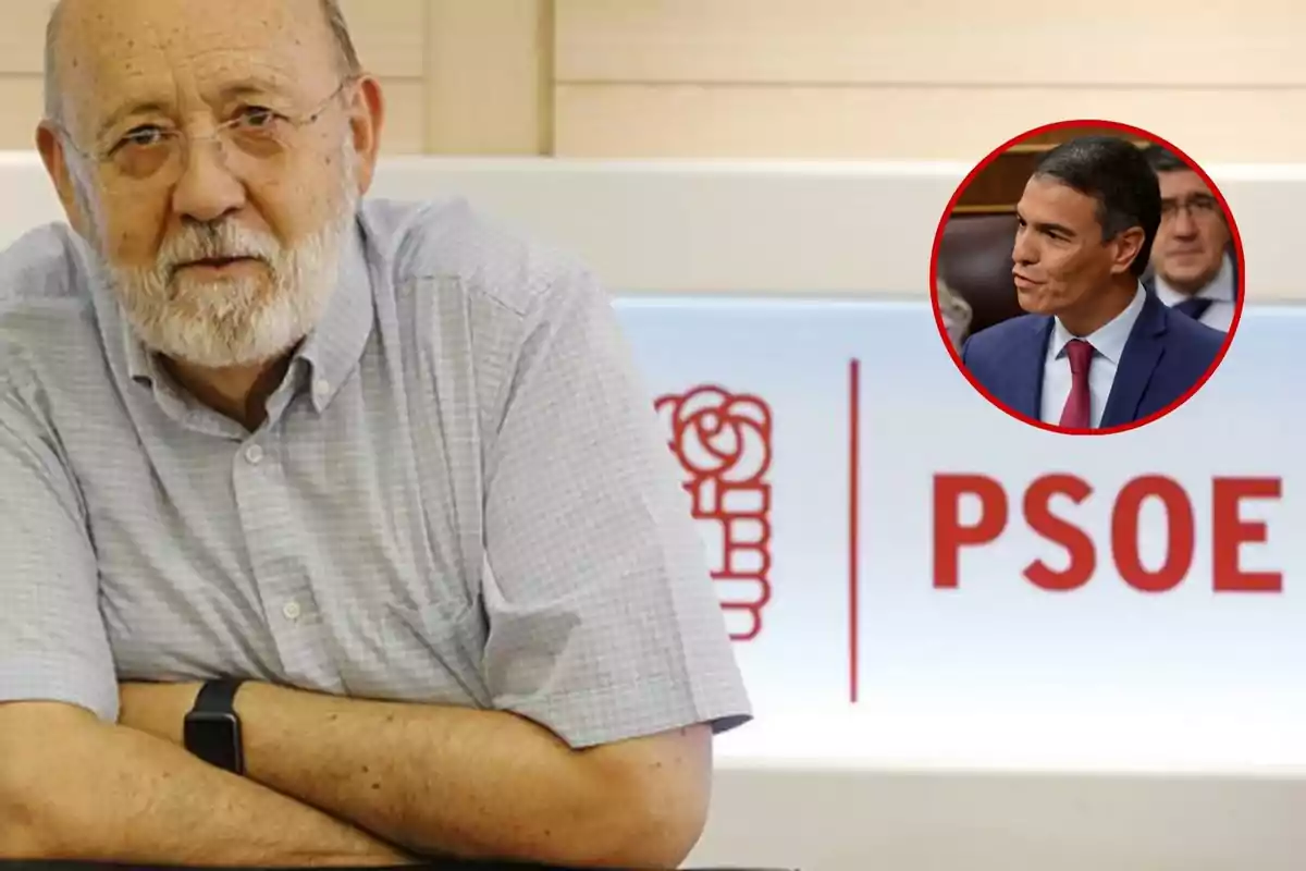 Un hombre mayor con barba y gafas está sentado frente a un cartel del PSOE, con una imagen circular de otro hombre en traje en la esquina superior derecha.